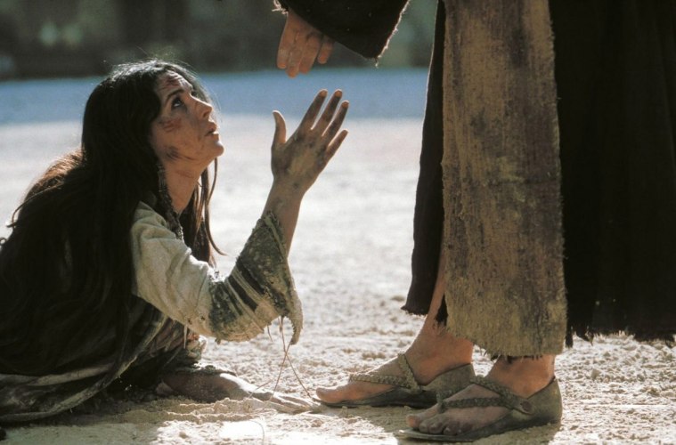 woman stretching hand out to Jesus